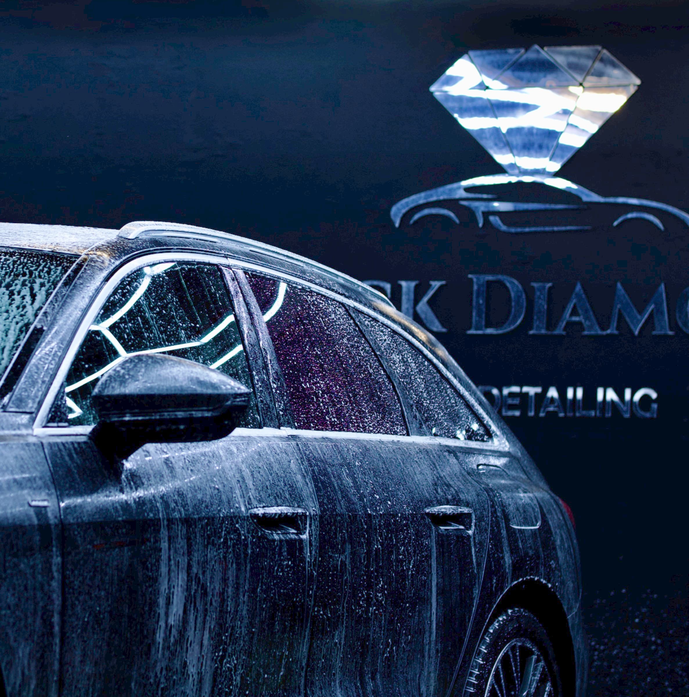 Black Diamond detailing bay with foam wash and wall logo
